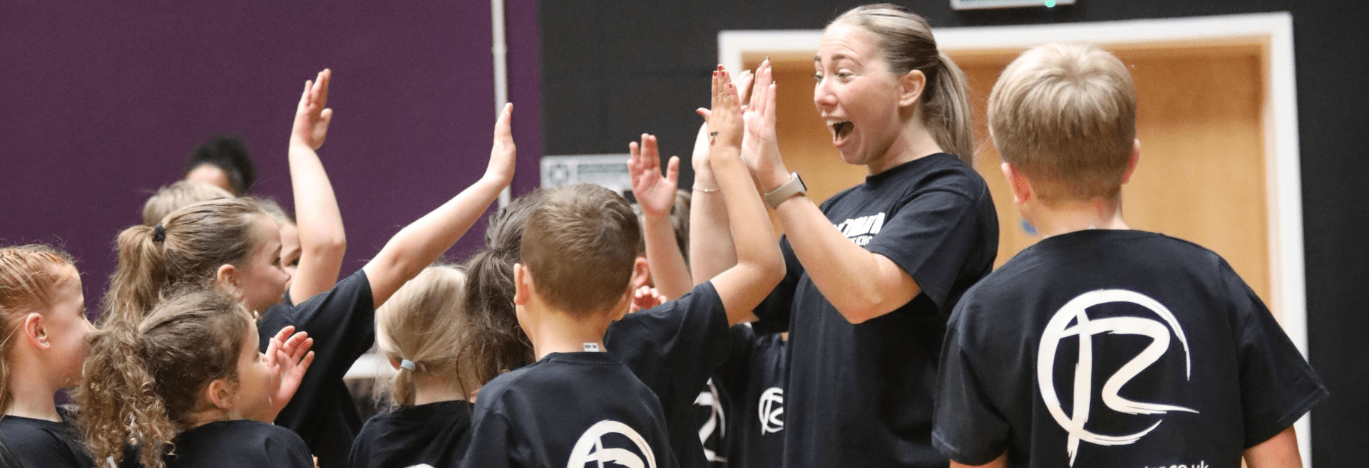 Students giving high fives to their teacher