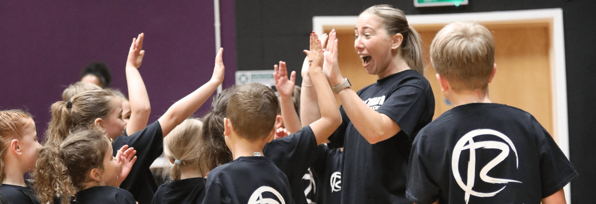 Teacher hi fiving students