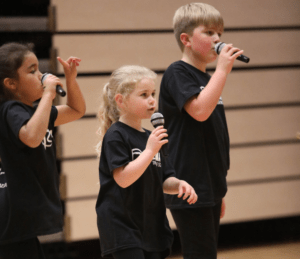 boy and girls holding microphone